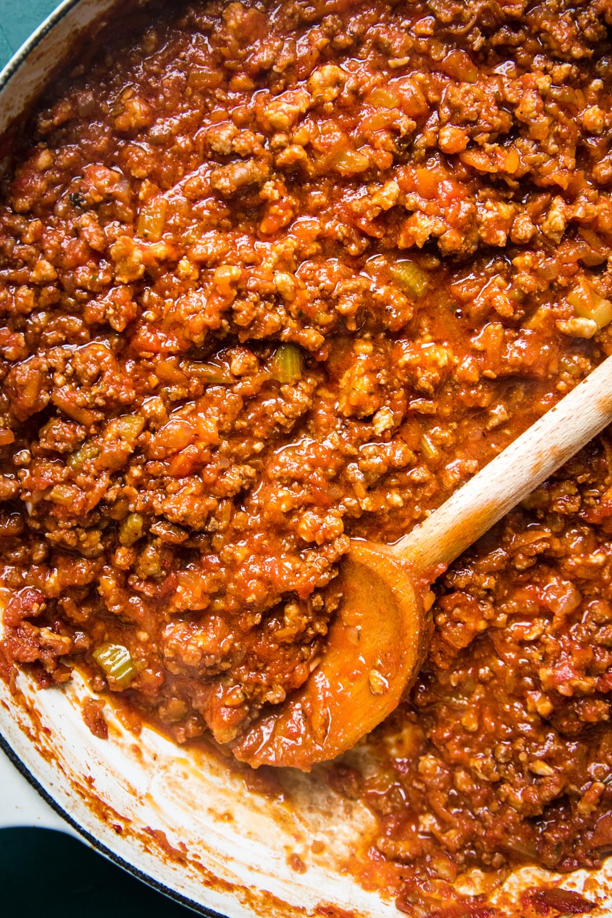 homemade simple ragù sauce in a pot with a wooden spoon