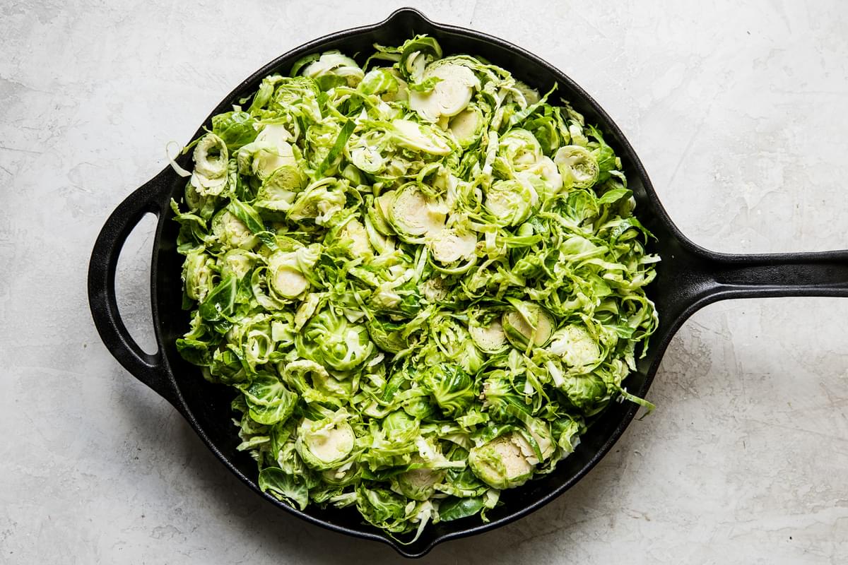 shaved brussel sprouts in a cast iron pan
