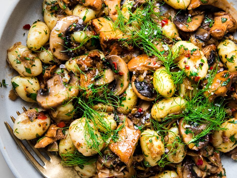 homemade Spicy Gnocchi with Fennel and Mushrooms in a bowl with a spoon