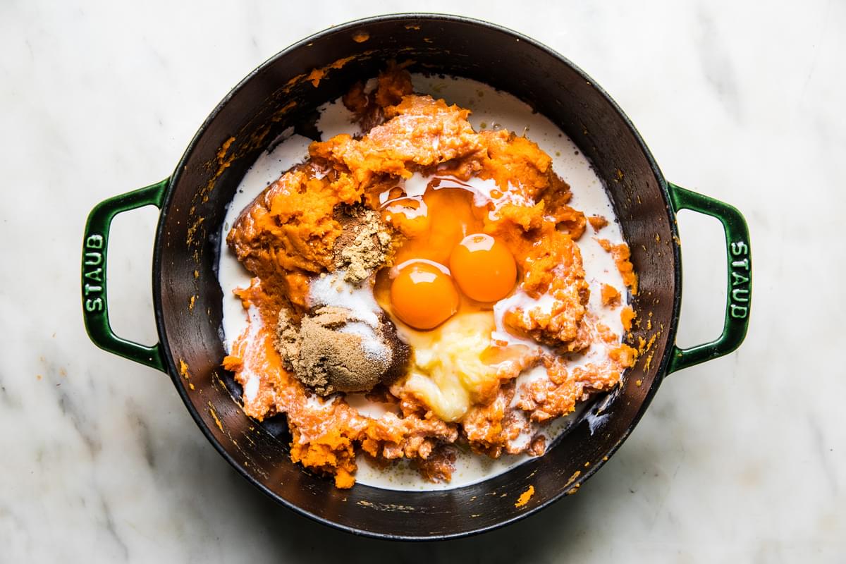 mashed sweet potatoes, butter, brown sugar, maple syrup, vanilla, lemon juice, heavy cream, eggs and spices  in a large pot