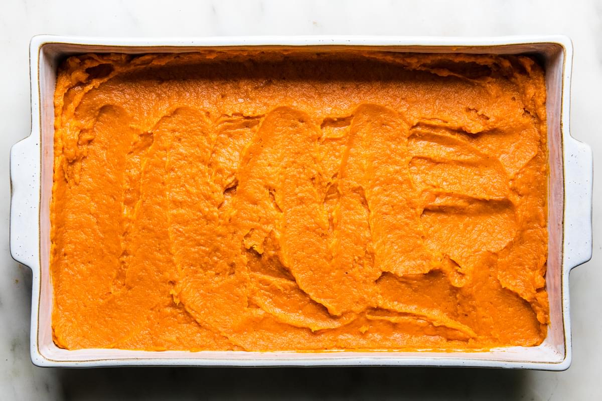 uncooked sweet potato casserole in a baking dish