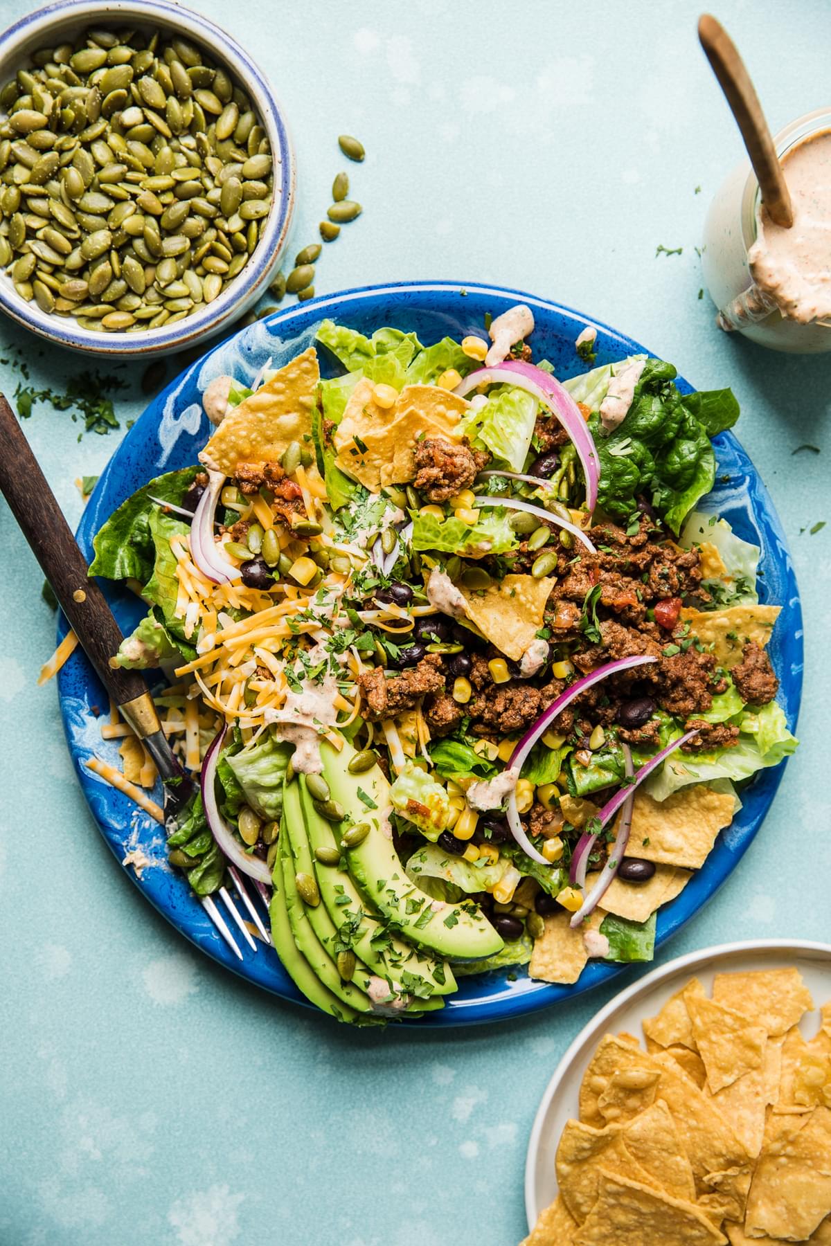 best taco salad recipe with on a plate with creamy sour cream salsa dressing.