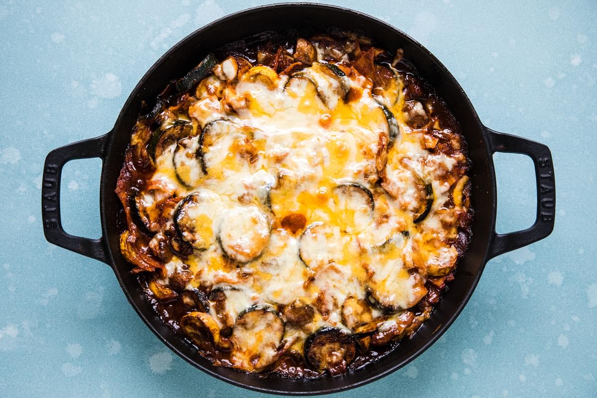 homemade vegetarian enchilada skillet topped with melted cheese just out of the oven