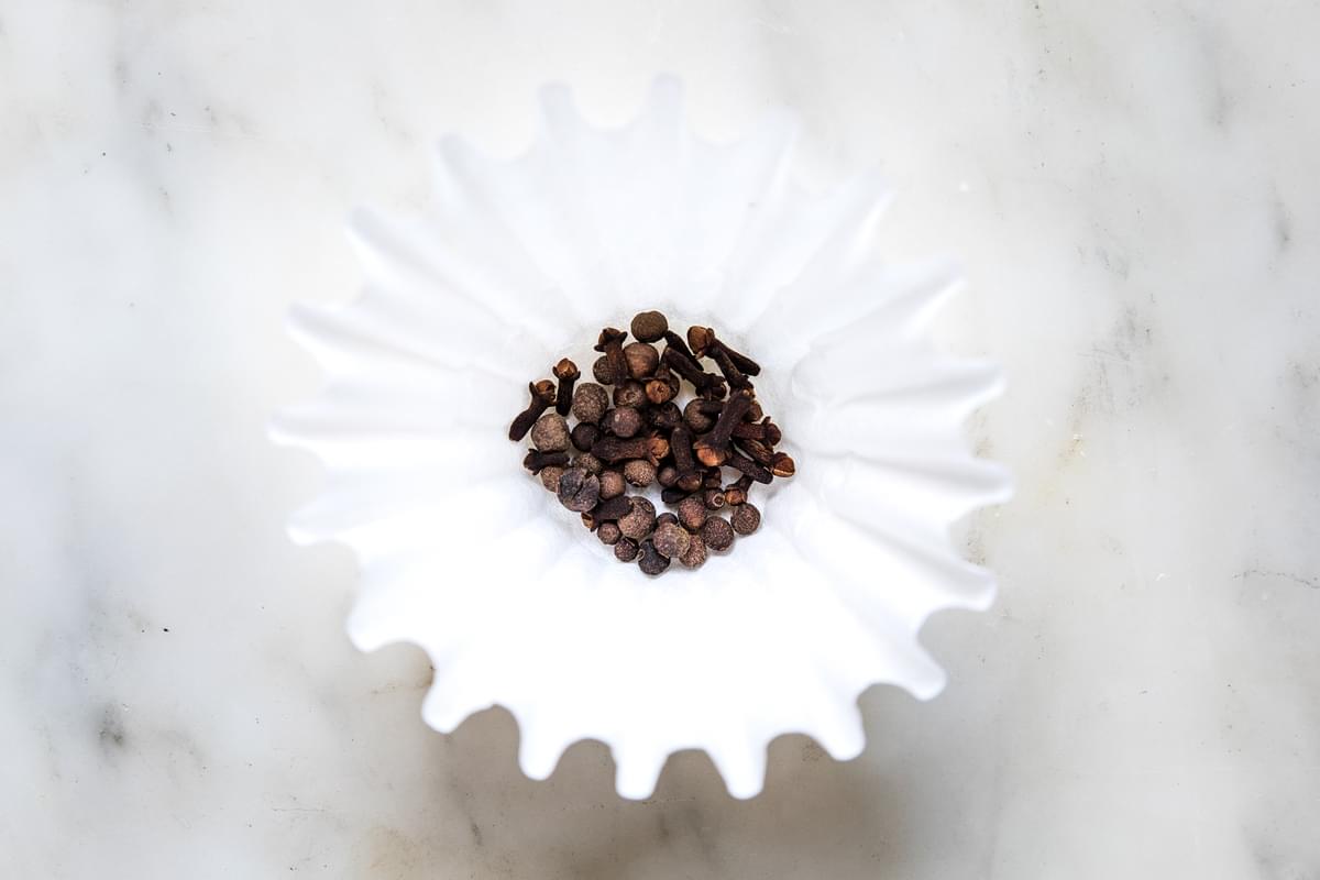 cloves and all spice in a coffee filter