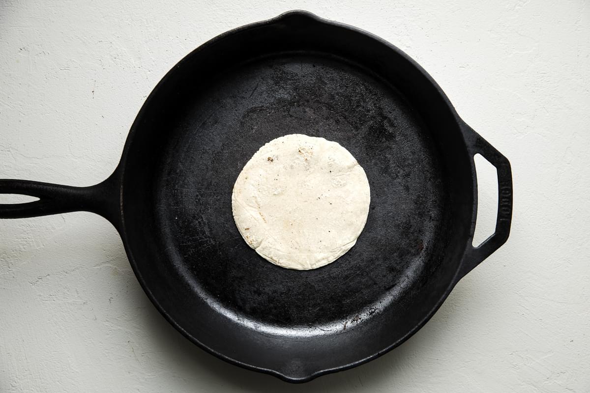 fresh homemade corn tortilla cooked in a cast iron skillet