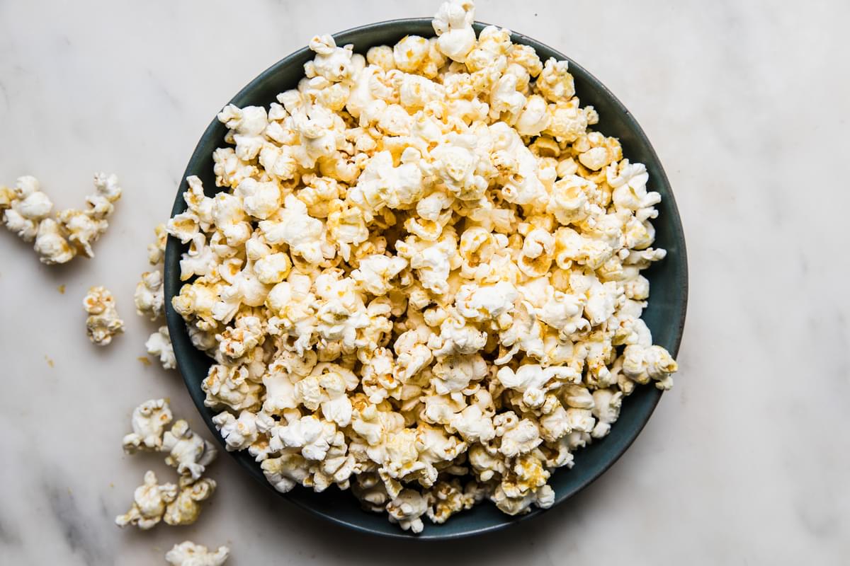 a bowl of homemade popcorn with browned butter and nutritional yeast in a bowl