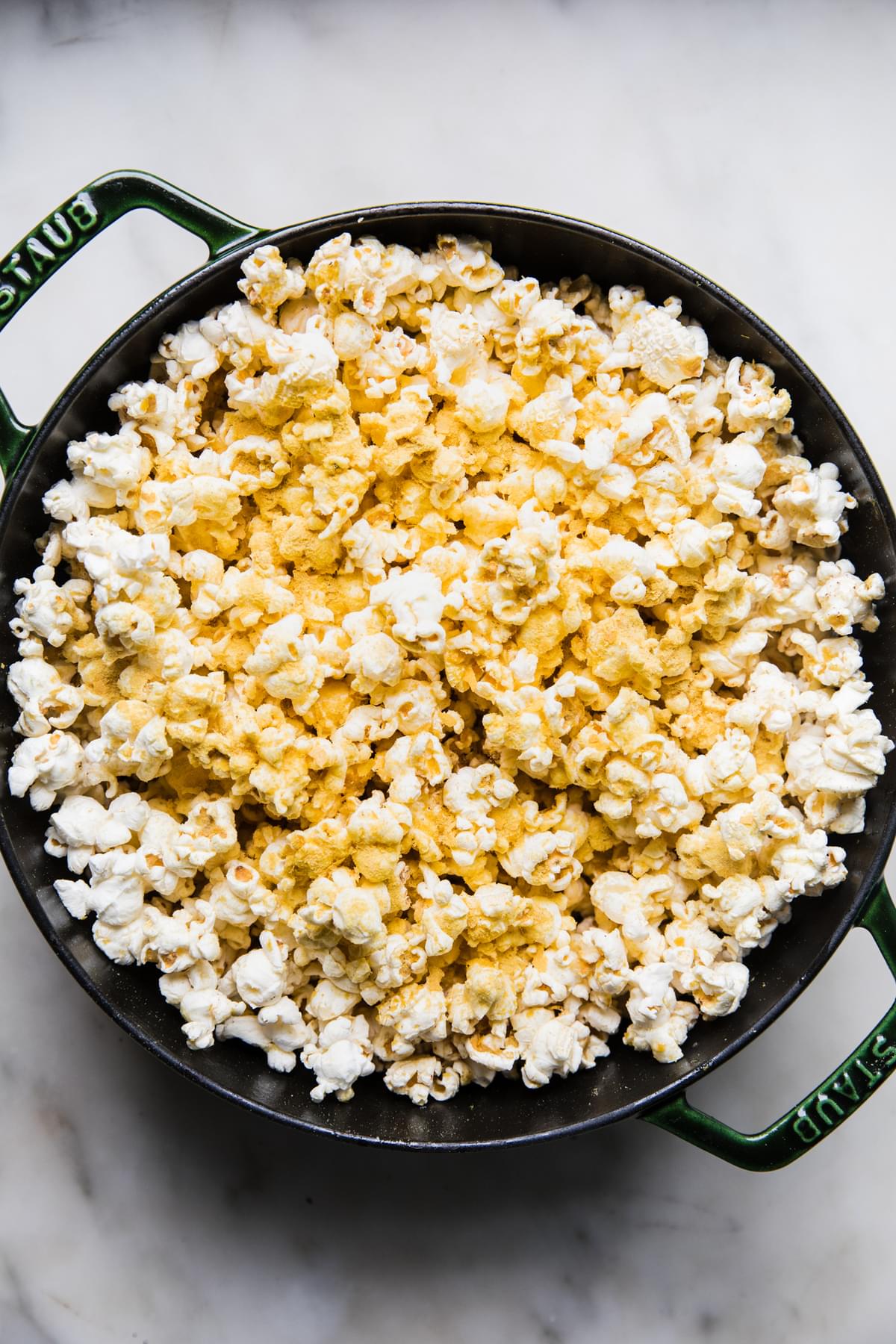 a dutch oven full of homemade buttered popcorn