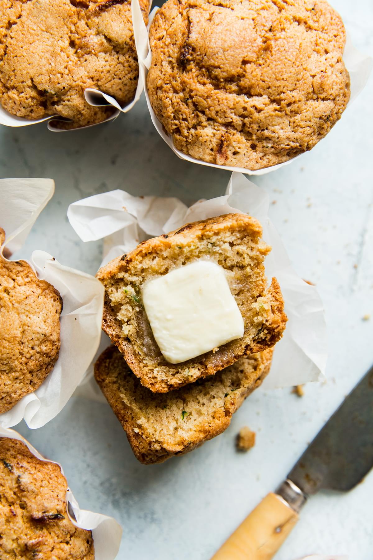 Moms zucchini bread muffins with a pat of butter