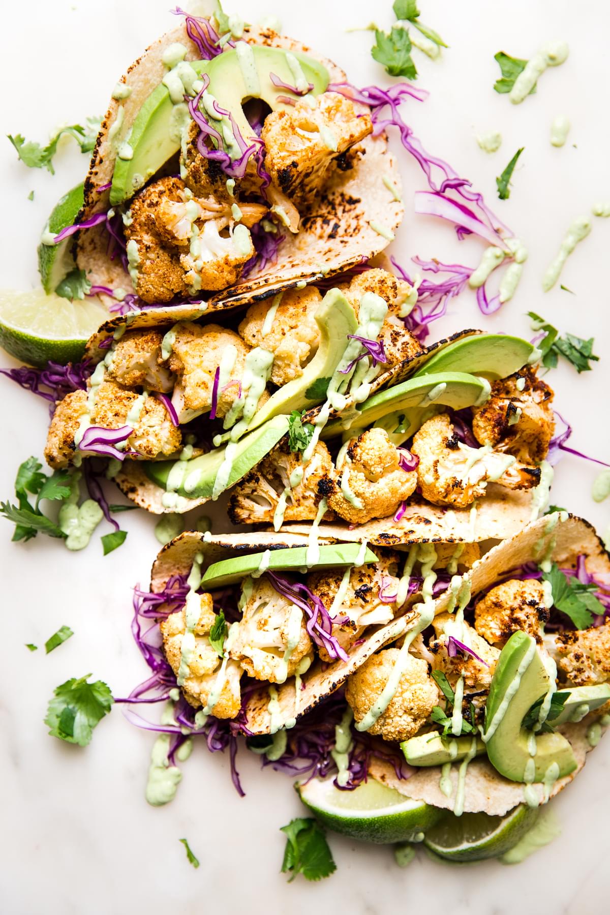 roasted cauliflower tacos with avocado cream and cabbage slaw