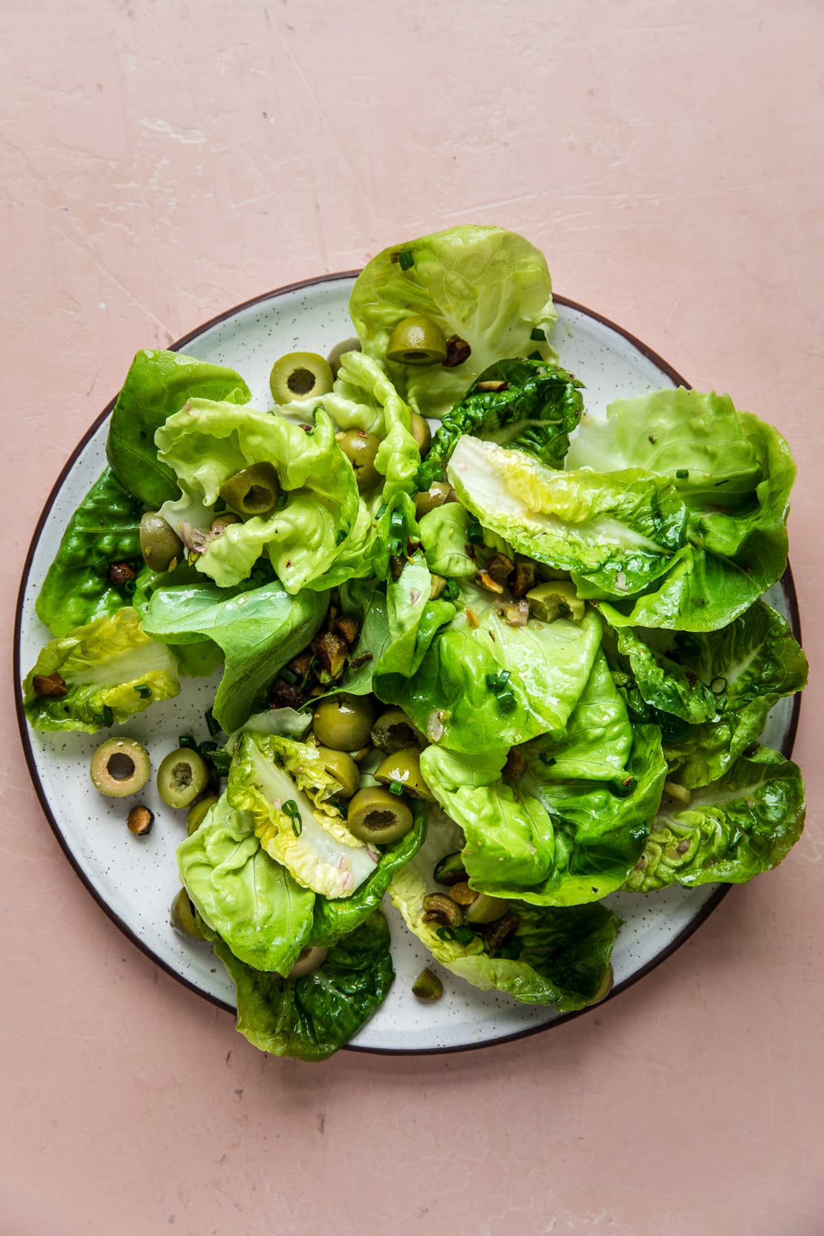 simple green salad with shallot vinaigrette olives and pistachios