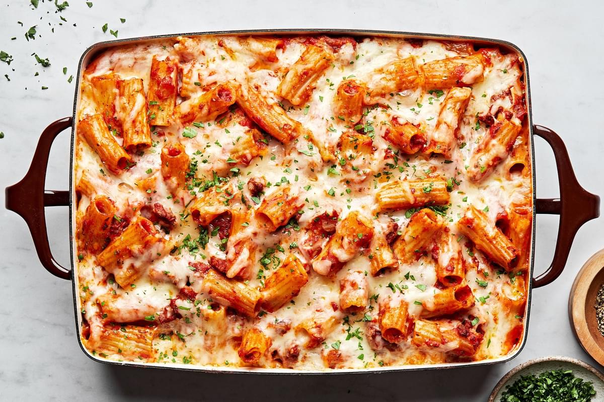 homemade baked rigatoni in a 9x13 casserole dish made with italian sausage, ground beef, marinara and mozzarella