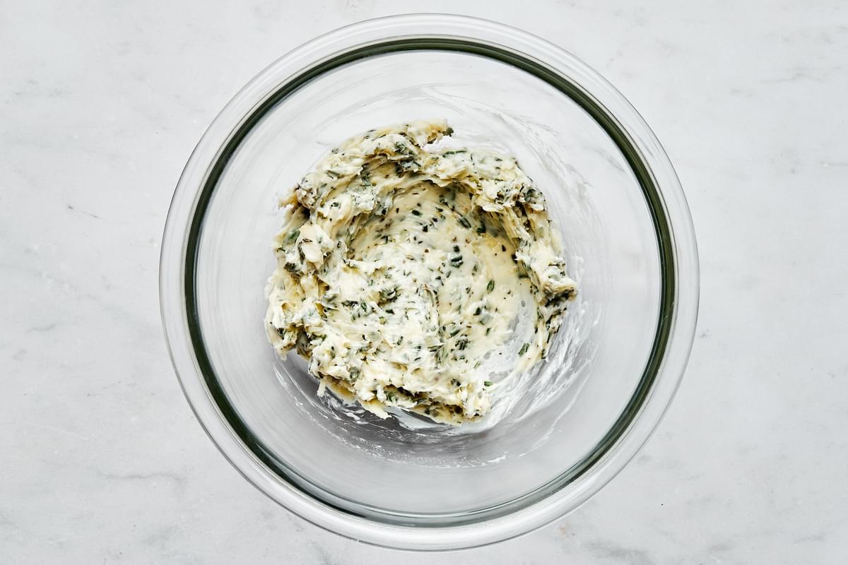 garlic herb butter in a bowl made with garlic cloves, fresh thyme, fresh rosemary and fresh sage