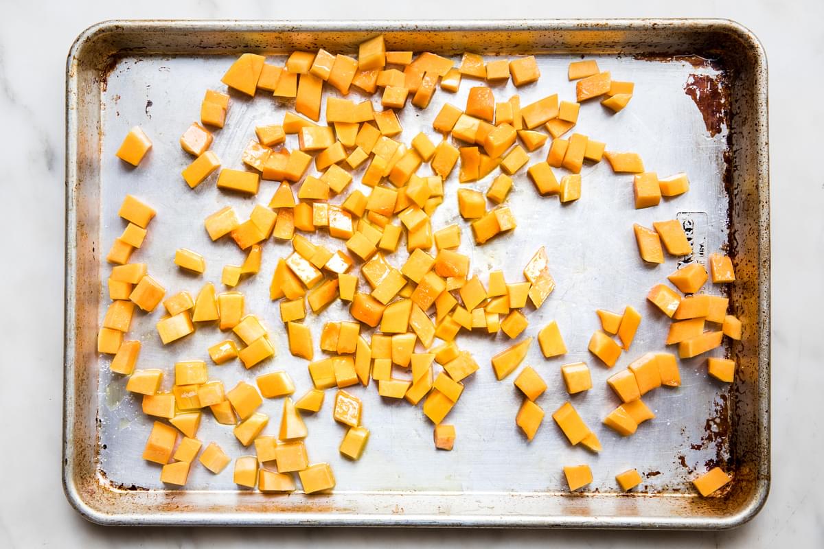 butternut squash on a baking sheet ready to be roasted in the oven