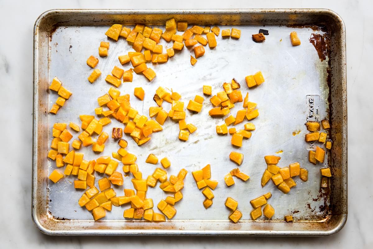 roasted cubed butternut squash on a baking sheet