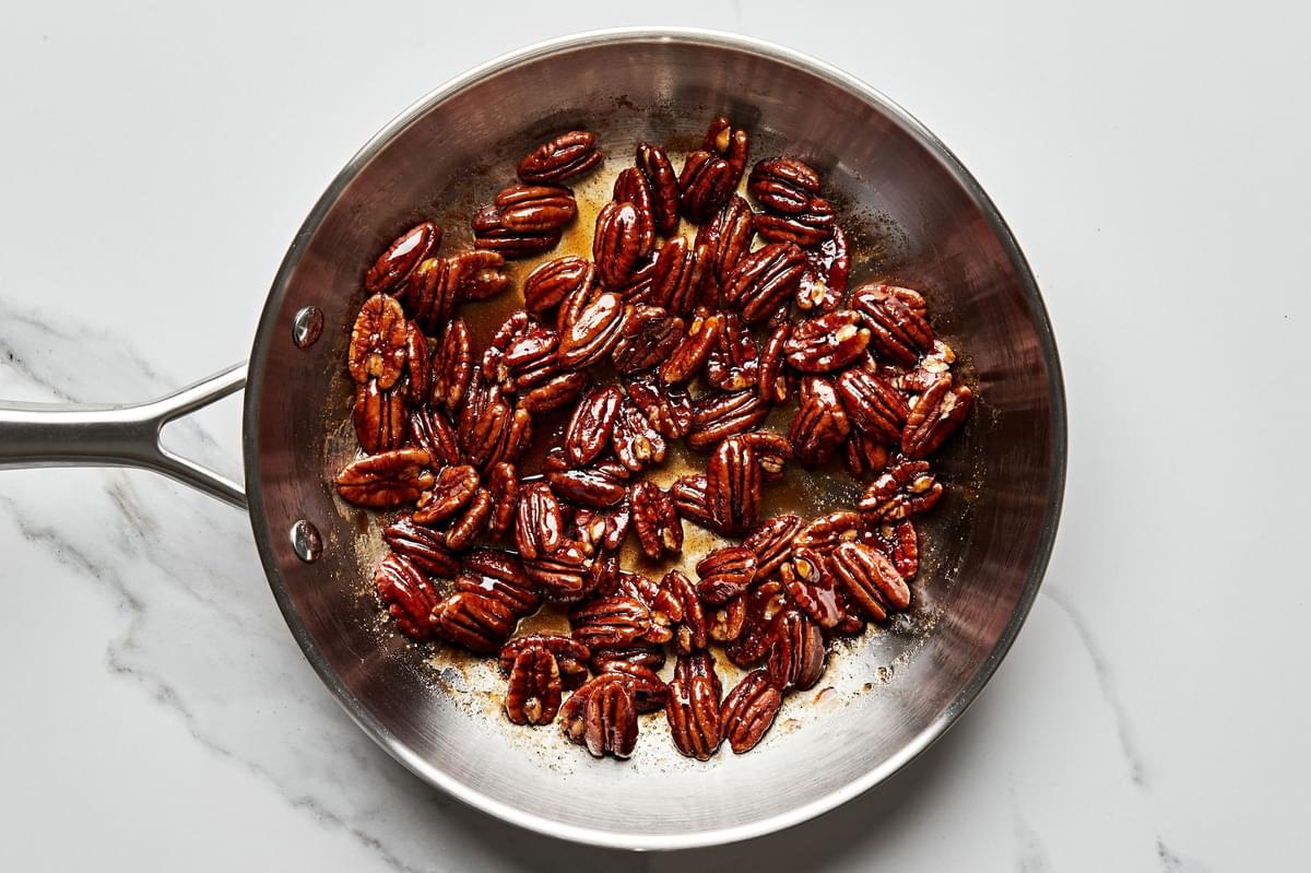 pecans in a skillet be candied in brown sugar, cinnamon, salt, cayenne pepper and water