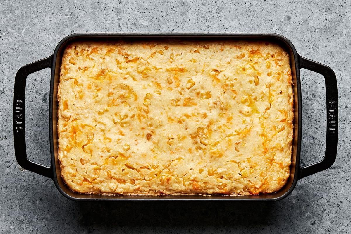 cheesy corn casserole that has just been baked and removed from the oven