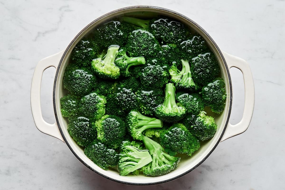 broccoli being cooked in a pot of salted water