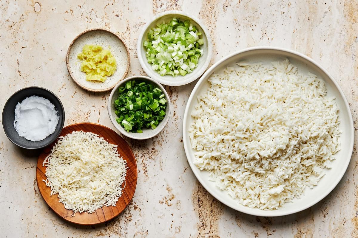 bowls of coconut rice, green onions, grated ginger, coconut oil and sweetened coconut flakes to make coconut fried rice