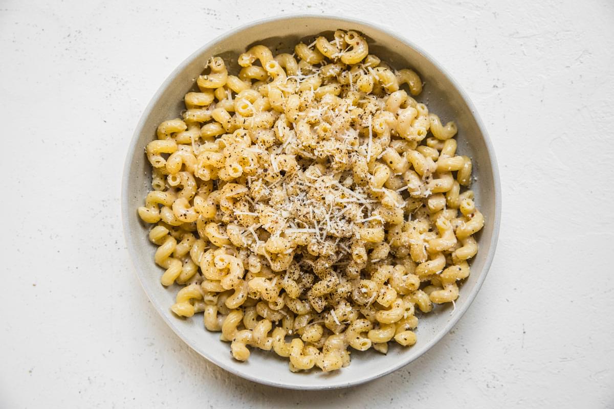 a bowl of homemade creamy cavatappi made with olive oil, Parmesan and freshly cracked pepper