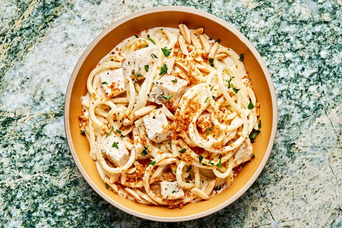 creamy turkey pasta in a bowl made with butter, spices, cream and parmesan