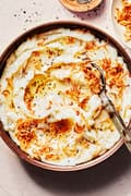 a bowl of homemade crispy shallot mashed potatoes made with butter, milk, garlic powder and salt