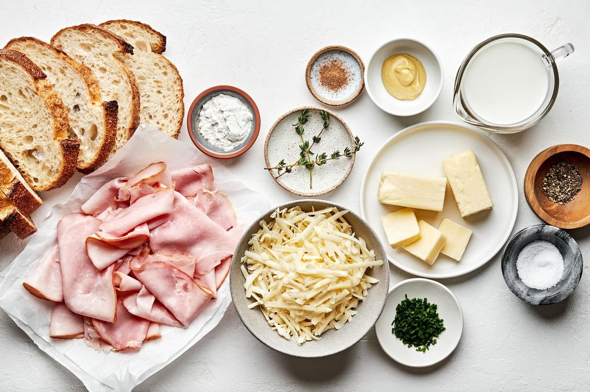 bread, ham, Gruyère, butter, flour, milk, dijon and spices in bowls to make croque monsieur