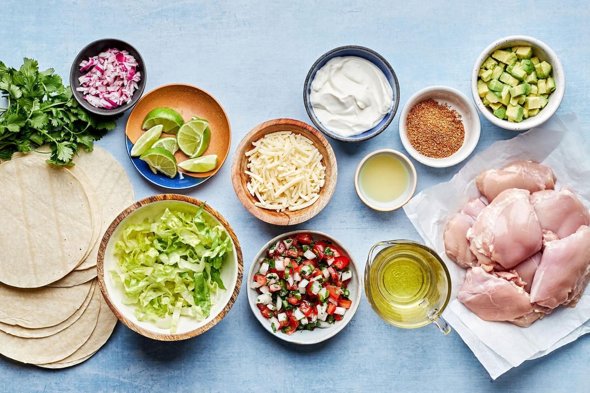 chicken, taco seasoning, olive oil, lime juice, tortillas, lettuce, cheese and pico in bowls to make easy chicken tacos
