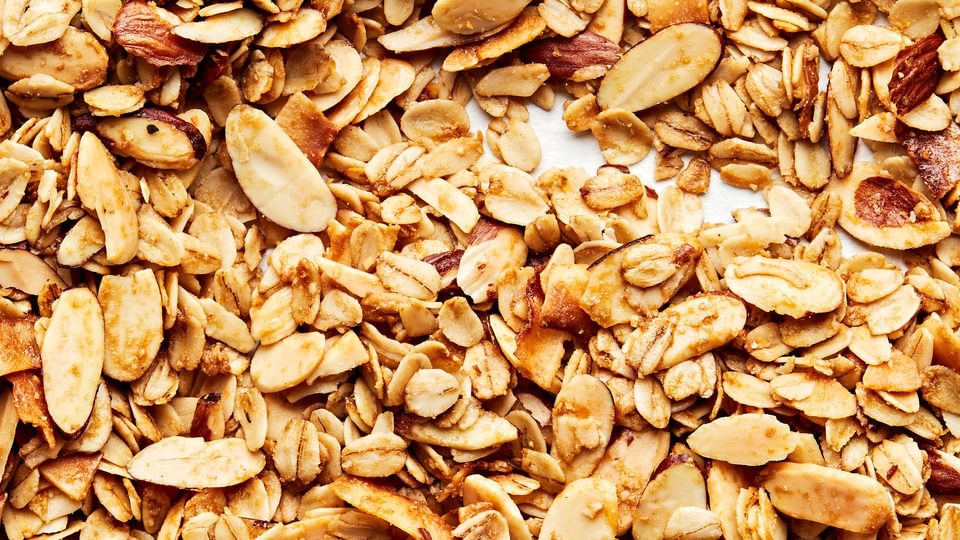 Easy Homemade Granola made with oats, almonds, salt, brown sugar, syrup, oil and vanilla extract