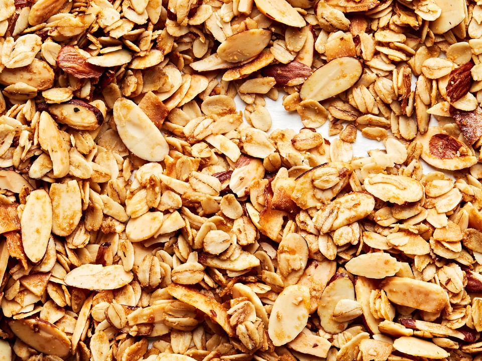 Easy Homemade Granola made with oats, almonds, salt, brown sugar, syrup, oil and vanilla extract
