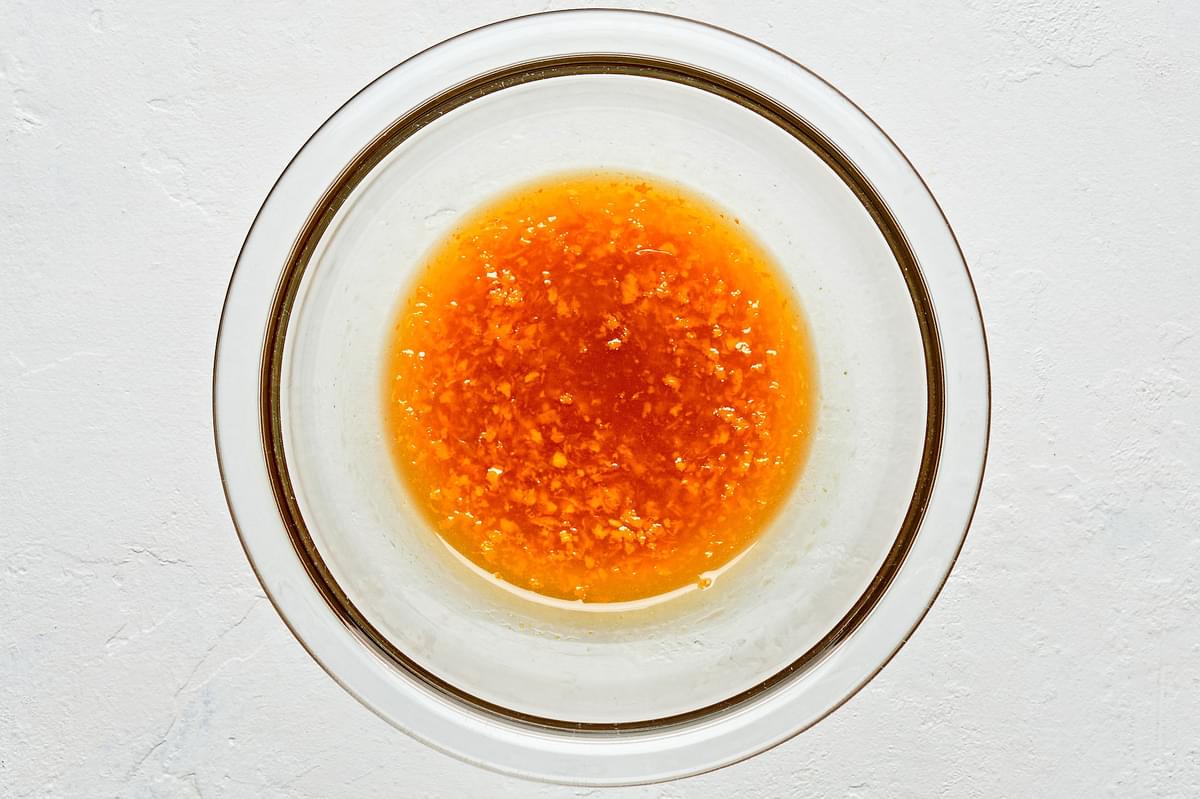 orange zest, orange juice brown sugar and vanilla mixed in a bowl for orange dressing to go on fruit salad