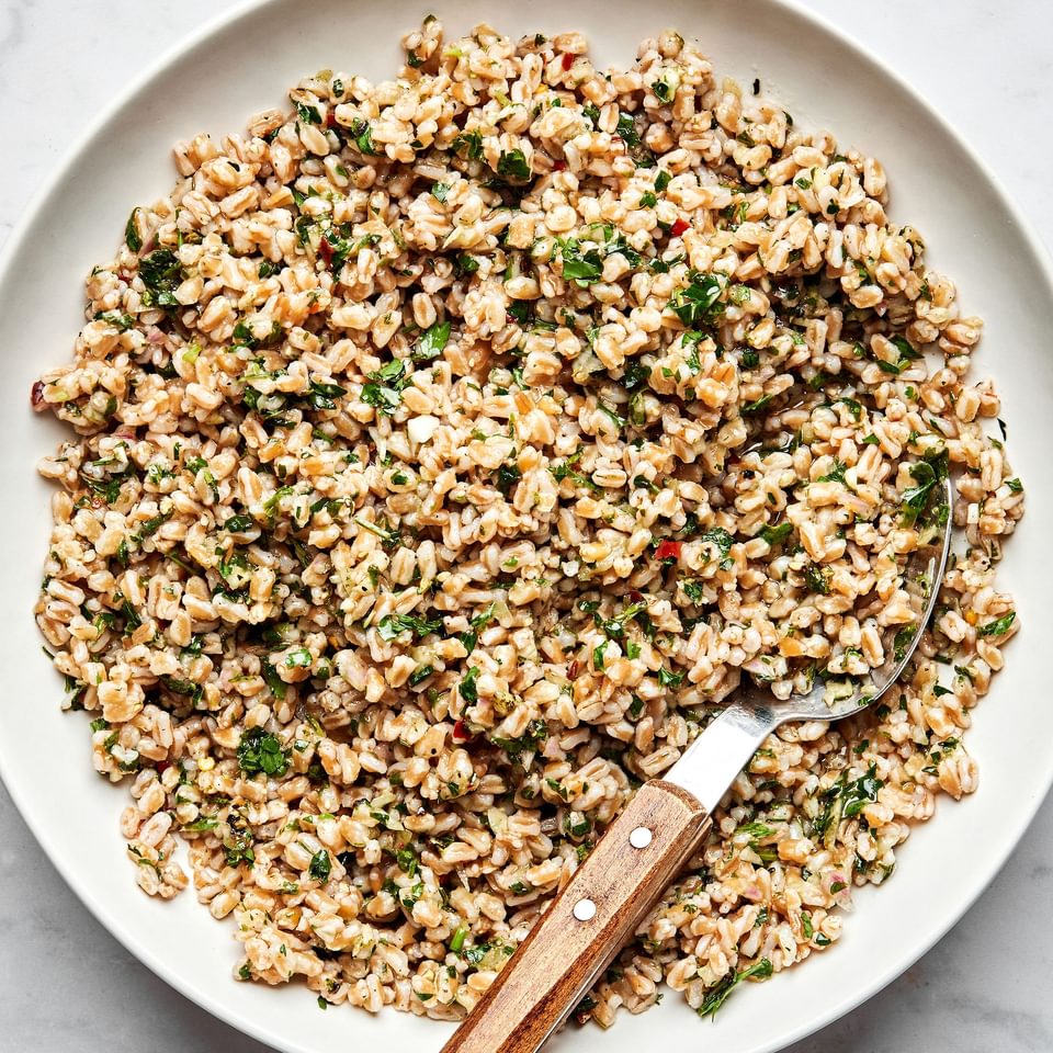 homemade farro in a serving bowl with a spoon