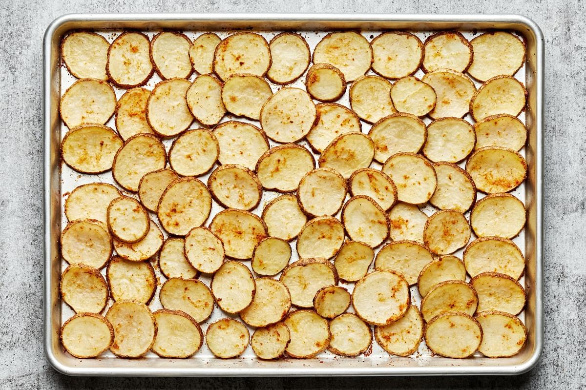 roasted potatoes on a baking sheet seasoned with garlic, onion and chili powders and salt