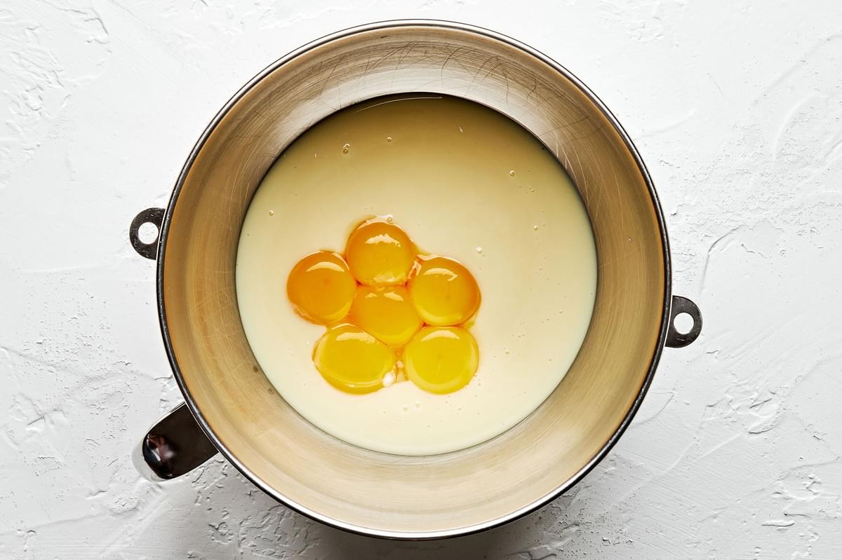 sweetened condensed milk and egg yolks in the base of a stand mixer for making key lime pie