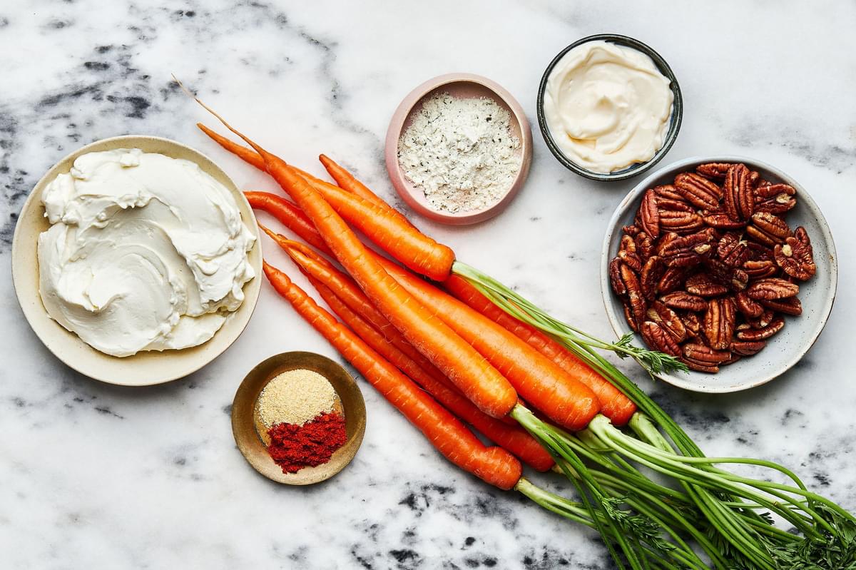 Carrots, Pecans, Cream cheese, Mayo, Ranch seasoning packet, Garlic powder and Cayenne in bowls on the counter to make dip