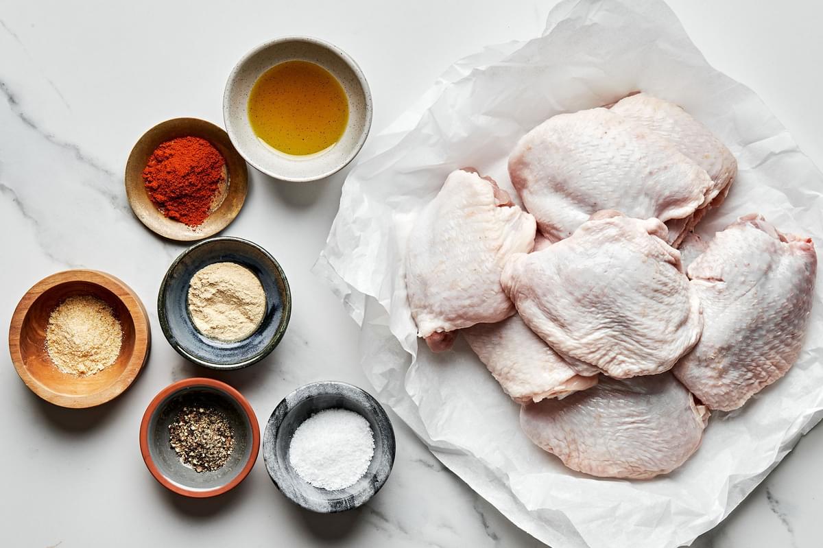 raw chicken thighs, olive oil, salt, garlic powder, onion powder, paprika, & pepper to make oven baked chicken thighs
