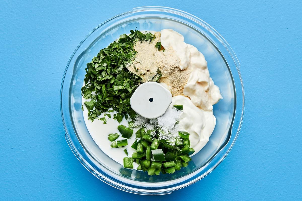 buttermilk, mayonnaise, sour cream, cilantro, jalapeno, onion powder, garlic powder, and salt in a food processor