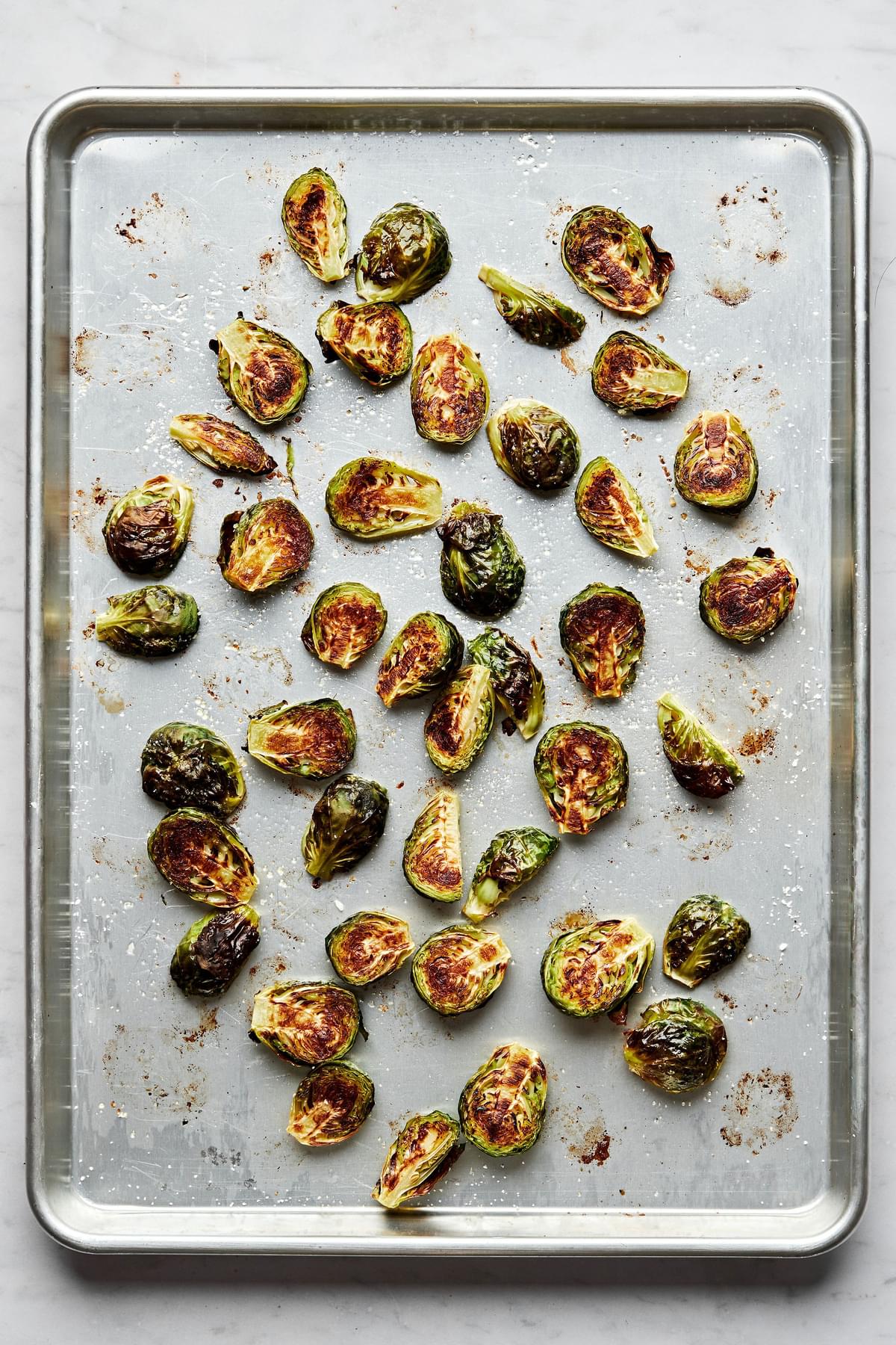 roasted Brussels sprouts on a baking sheet just out of the oven with caramelized, crunchy outsides and soft interiors
