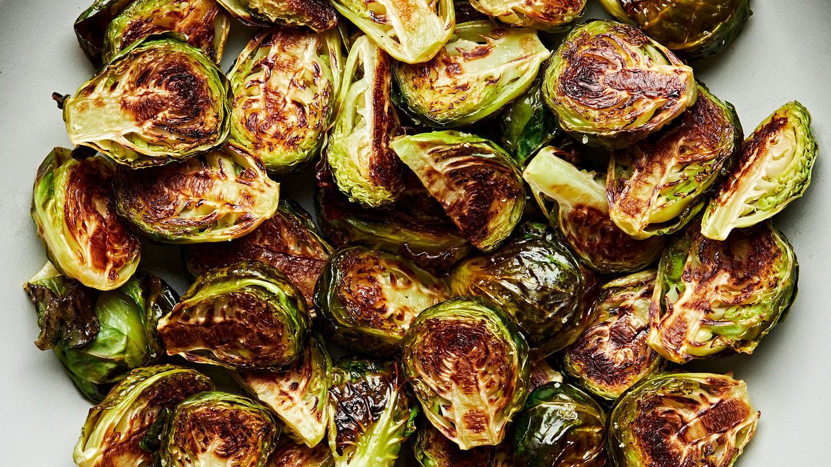 roasted brussels sprouts in a serving bowl seasoned with olive oil and salt