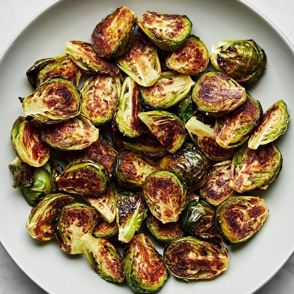 roasted brussels sprouts in a serving bowl seasoned with olive oil and salt