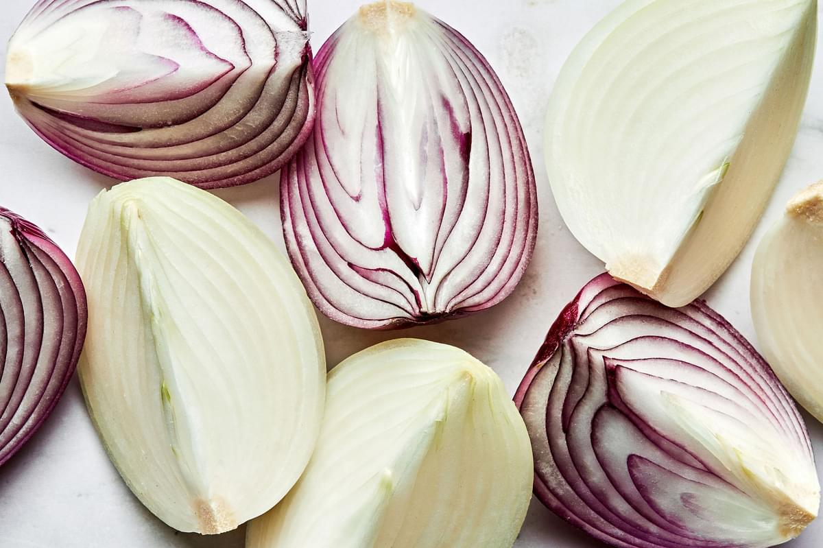 raw red and yellow onions cut into large wedges to make roasted onions