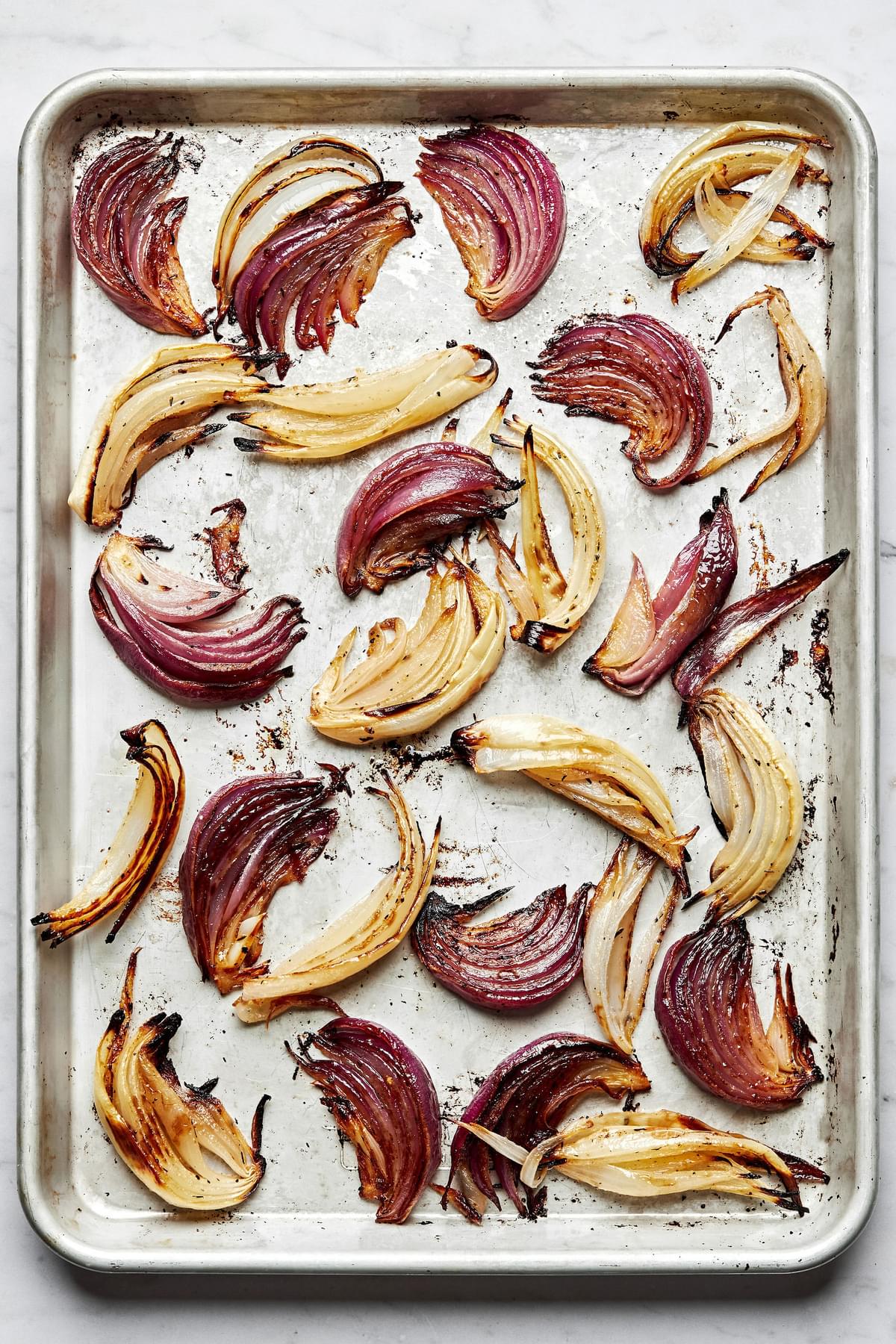 roasted onions on a baking sheet made with olive oil, red wine vinegar, lemon juice, dijon, spices and brown sugar