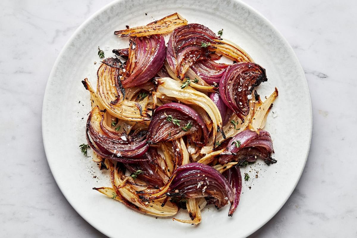 roasted onions on a plate made with olive oil, red wine vinegar, lemon juice, dijon, spices and brown sugar