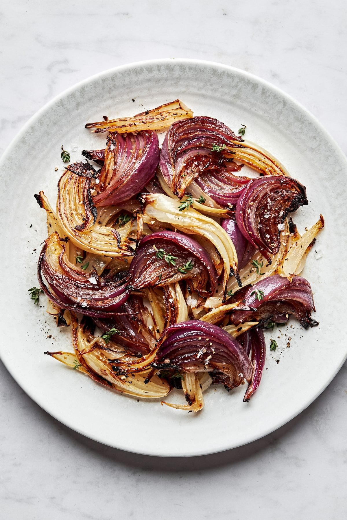 roasted onions on a plate made with olive oil, red wine vinegar, lemon juice, dijon, spices and brown sugar
