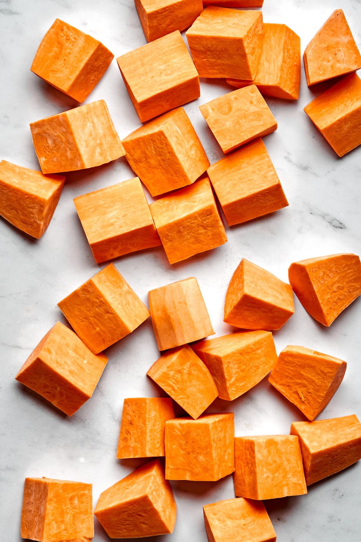 raw cubed sweet potatoes ready to be seasoned and roasted