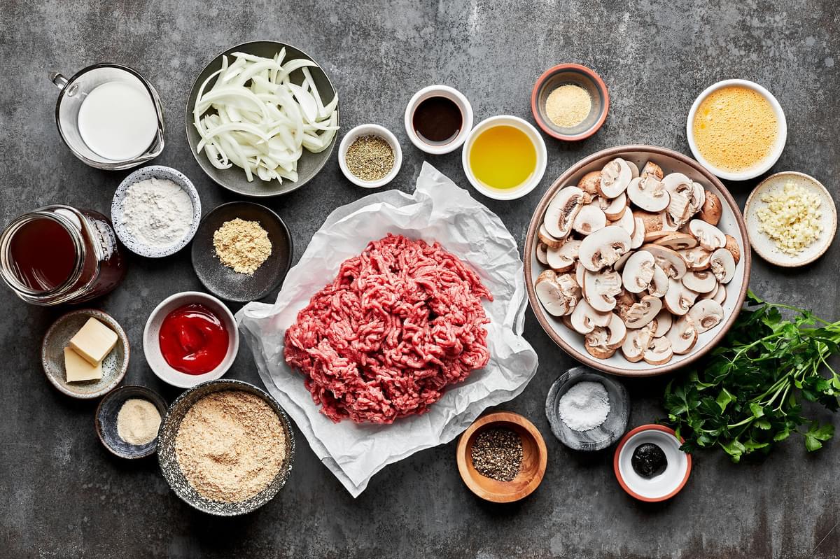 ingredients for Salisbury steak on the counter. Ground beef, mushrooms, onions, butter, spices, garlic, ketchup