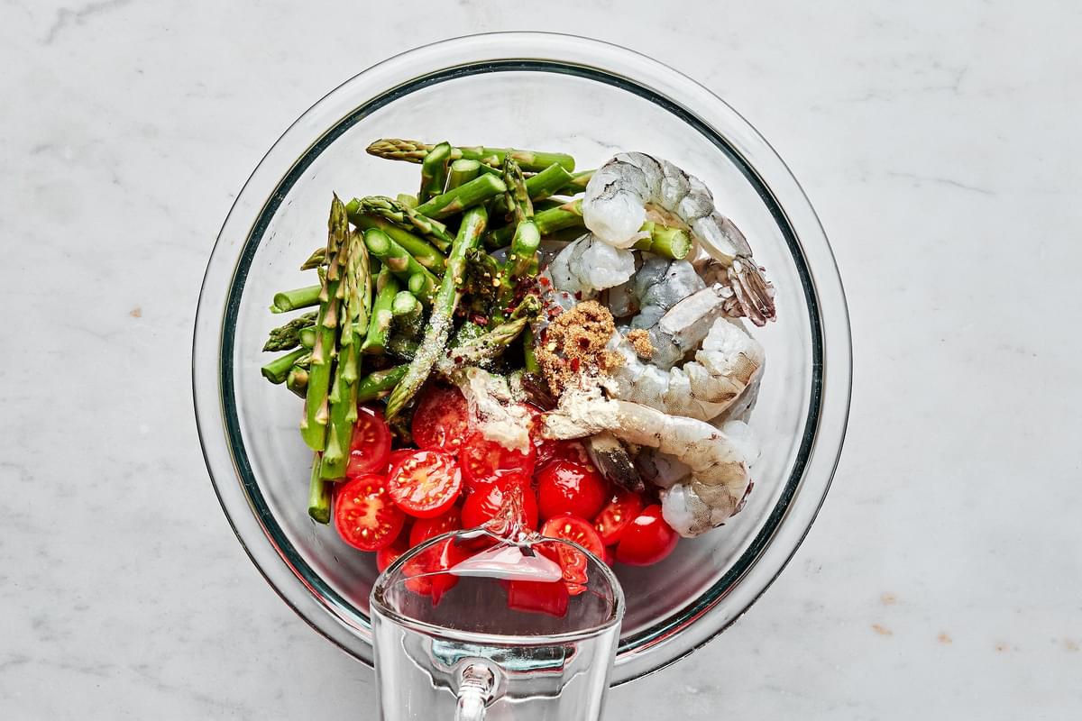 shrimp, asparagus, tomatoes, olive oil, wine, lemon juice, salt, brown sugar, red pepper flakes & garlic powder in a bowl