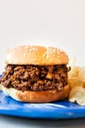 homemade sloppy Joe recipe on a plate next to chips