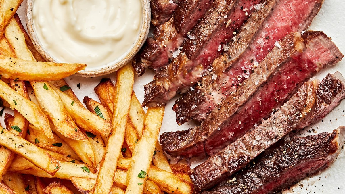 Homemade Steak Frites on plate served with garlic aioli