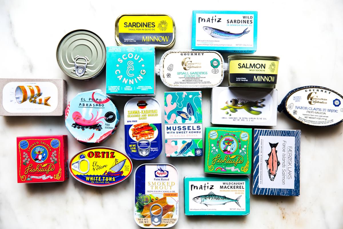 Various tin fish packages shown on a white surface.