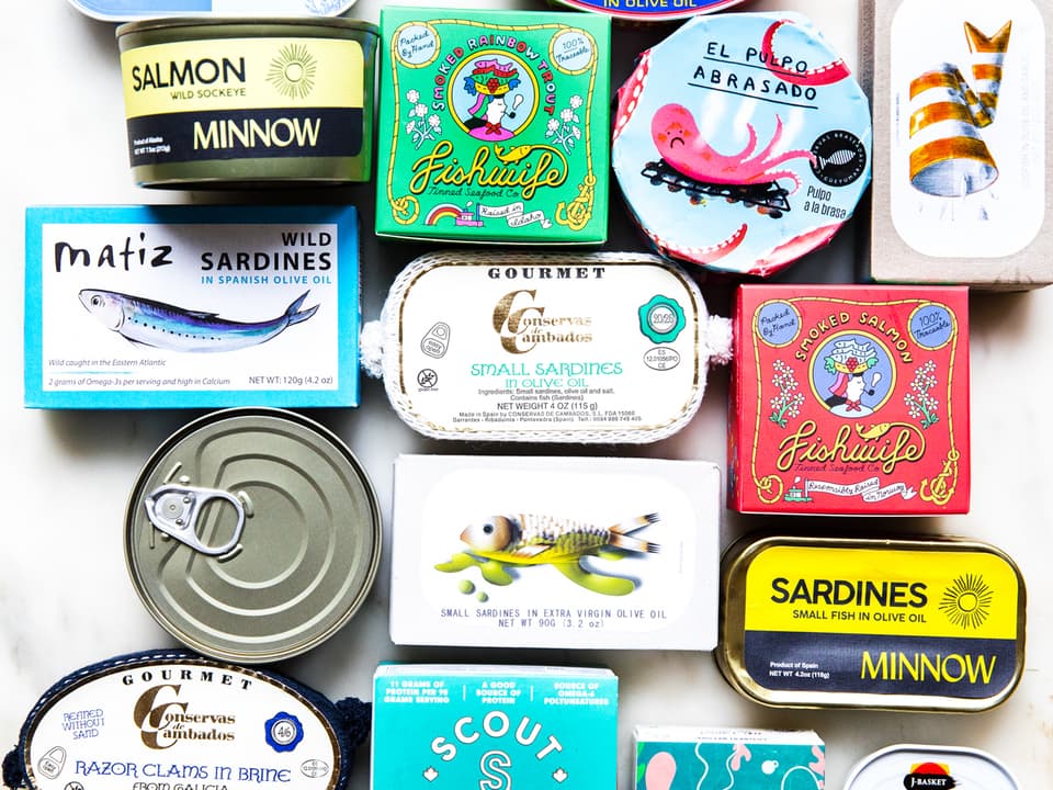 White background with various tin fish packages lined up